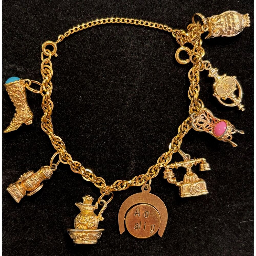 Vintage 1973 Avon Signed Gold Tone Eight Charm Link Bracelet